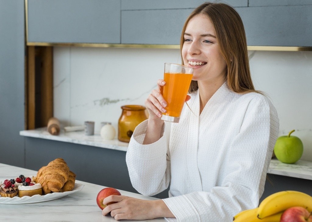 smiley-woman-in-bathrobe-drinking-juice.jpg