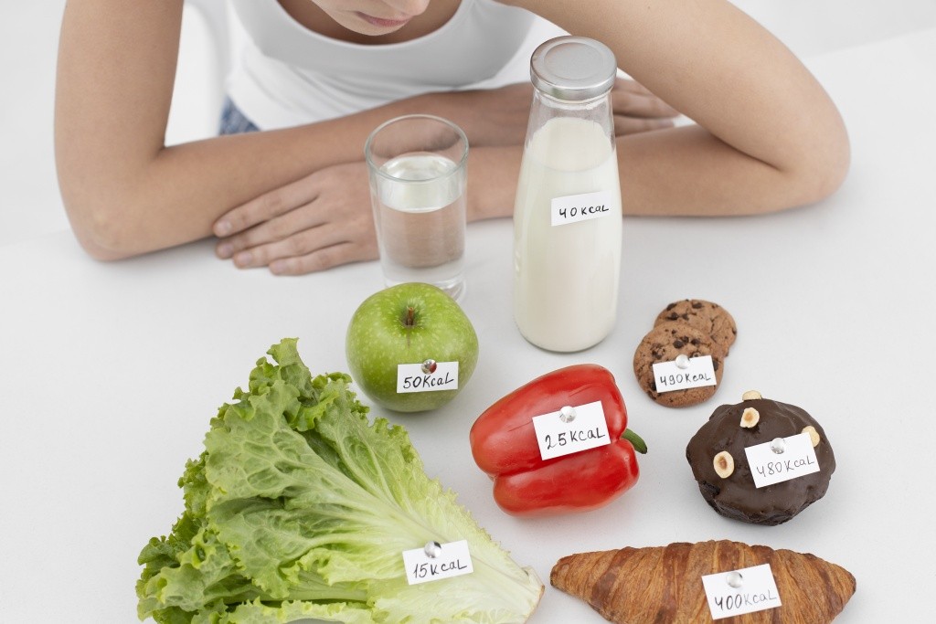 young-woman-with-eating-disorder-food-with-calories-numbers.jpg
