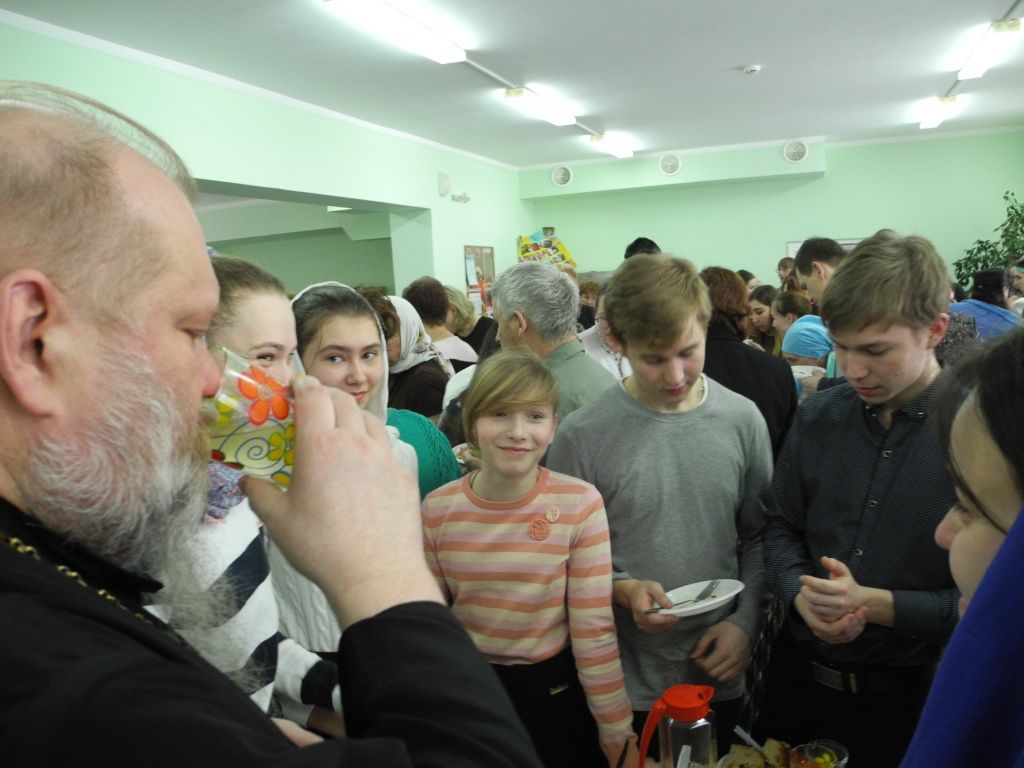 Батюшка Гермоген дегустирует блюда хора "Благовест". (фото Натальи Кулишовой).