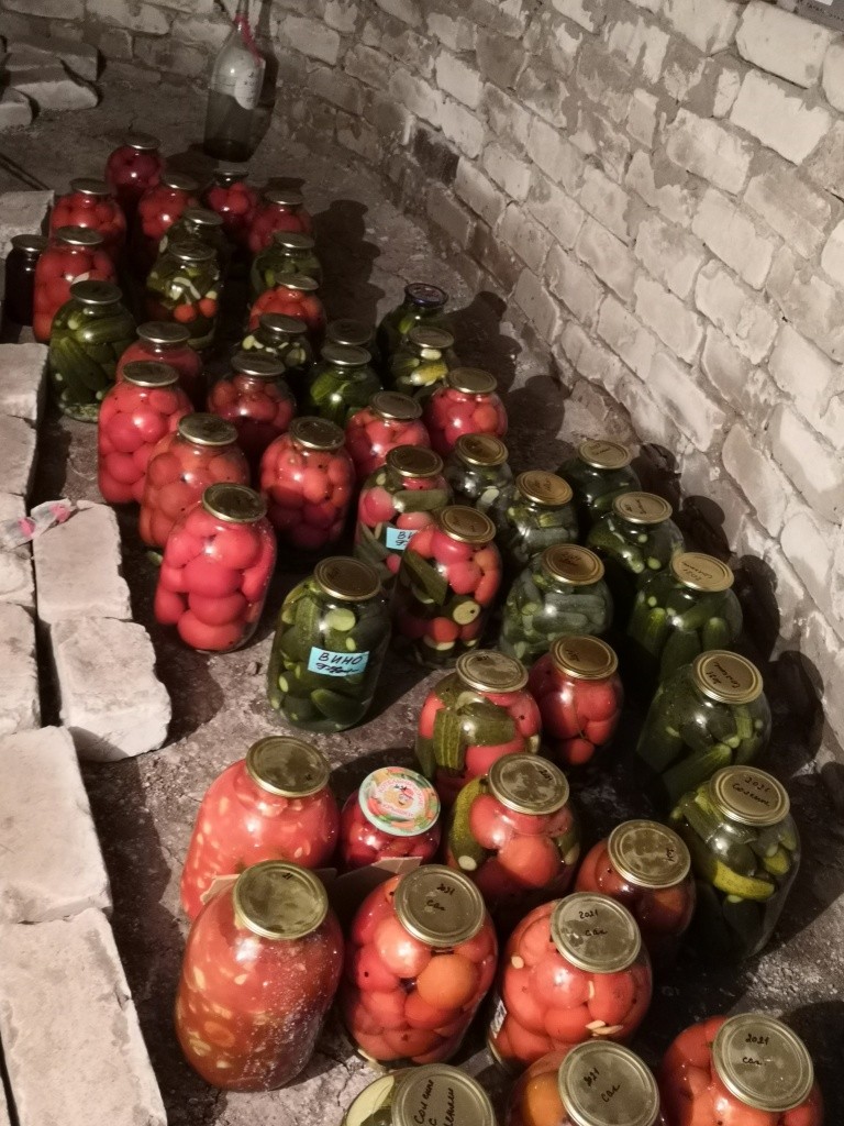 На полках заготовкам не хватило места, поэтому банки стоят и на полу.jpg